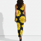 A striking sleeveless black bodycon maxi dress adorned with oversized bright yellow sunflower prints for a bold, vibrant statement.