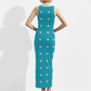 A sleeveless teal bodycon maxi dress decorated with soft pink polka dots for a fun, playful, and retro-inspired look.