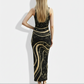 A sleeveless black bodycon maxi dress featuring flowing gold wave patterns and speckled accents for a luxurious, artistic statement.