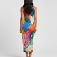 A sleeveless, bodycon midi dress adorned with a vibrant multicolor feather print, creating a bold and artistic statement silhouette.