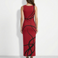 A sleeveless, fitted red midi dress featuring bold black abstract swirl lines for a striking, modern statement look.