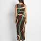A sleeveless, bodycon maxi dress in deep brown featuring flowing abstract lines in beige and teal for a bold, contemporary look.
