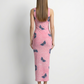 A sleeveless, fitted pink midi dress with a soft textured finish and scattered dark butterfly prints for a delicate, feminine look.