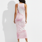 A sleeveless blush-pink bodycon midi dress with a soft marble print and delicate gold accents for an elegant, feminine look.