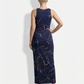 A sleeveless navy blue bodycon maxi dress adorned with elegant swirling gold line patterns for a refined, contemporary look.