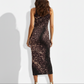 A sleeveless black bodycon midi dress featuring a subtle gold-speckled, starry print for a sleek and sophisticated evening look.
