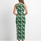 A sleeveless, bodycon green midi dress adorned with a repeating pattern of soft pink floral motifs for a fresh, playful look.