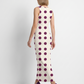 A sophisticated sleeveless bodycon maxi dress featuring a soft ivory base with bold plum polka dots, offering a timeless blend of elegance and vintage charm.