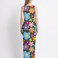 A vibrant sleeveless bodycon maxi dress featuring a dark base adorned with colorful retro floral prints, creating a playful, vintage-inspired, and cheerful aesthetic.