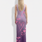 A graceful sleeveless bodycon maxi dress featuring a soft lavender-to-deep-purple ombré base adorned with delicate pink heart and floral vine motifs, creating a romantic and elegant look.