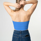A minimalist strapless tube top in a vibrant solid blue with a smooth, clean, and modern finish.