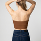 A minimalist strapless tube top in a rich solid chocolate brown with a smooth, clean finish.