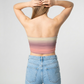 A strapless tube top featuring a soft horizontal gradient blending beige, blush pink, and muted rose tones for a subtle, dreamy look.