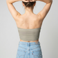 A minimalist strapless tube top in a smooth solid taupe shade with a clean, understated design.