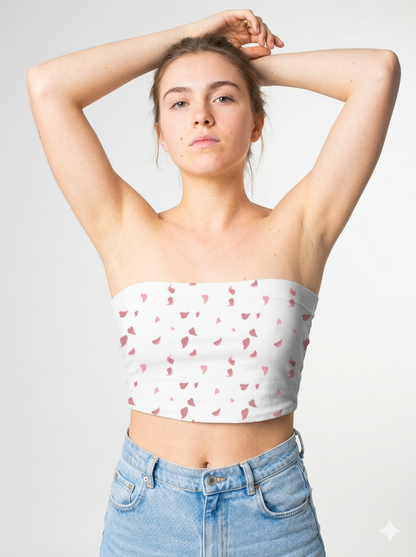 A white strapless tube top featuring a delicate scattered pattern of small dusty pink abstract petal-like shapes for a soft, minimalist look.