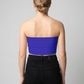 A minimalist strapless tube top in a bold cobalt blue with a smooth, clean, and striking finish.
