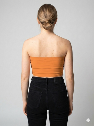 A minimalist strapless tube top in a vibrant solid orange with a smooth, clean, and energetic finish.