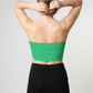 A minimalist strapless tube top in a bright solid green with a smooth, clean, and fresh finish.