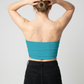 A minimalist strapless tube top in a vibrant teal blue with a smooth, clean, and modern finish.