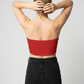 A minimalist strapless tube top in a bold solid red with a smooth, clean, and striking finish.