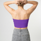 A minimalist strapless tube top in a vibrant purple hue with a smooth, clean, and bold finish.