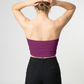 A minimalist strapless tube top in a rich magenta-purple shade with a smooth, clean, and bold finish.