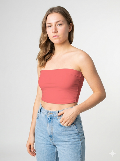 A minimalist strapless tube top in a soft coral pink with a smooth, clean, and vibrant finish.